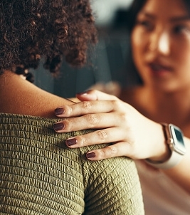 Friends, women and hands on shoulder for support with breakup, depression and relationship advice. Empathy, compassion and person with comfort for stress, overthinking and mental health in apartment
