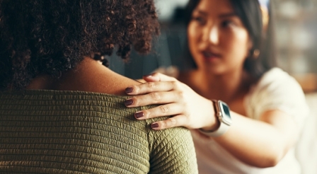 Friends, women and hands on shoulder for support with breakup, depression and relationship advice. Empathy, compassion and person with comfort for stress, overthinking and mental health in apartment