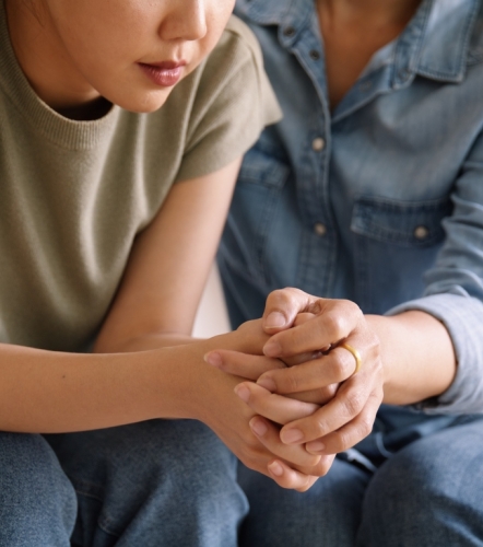 Middle aged asia people old mom holding hands trust comfort help young woman talk crying stress relief at home. Mum as friend love care hold hand adult child feel pain sad worry of life crisis issues.