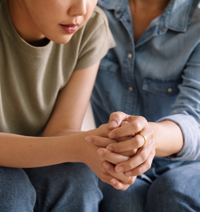 Middle aged asia people old mom holding hands trust comfort help young woman talk crying stress relief at home. Mum as friend love care hold hand adult child feel pain sad worry of life crisis issues.